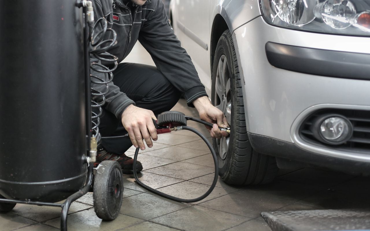 Air compressor being used for tyre inflation in a garage